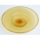 A large amber glass dish with folded rim engraved to the base Baccarat, 41cm in diameter.