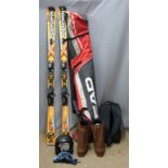 Pair of Rossignol skis together with a pair of boots, helmet and travel bags
