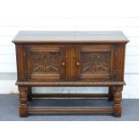 A carved oak two door cabinet/ small sideboard, W107 x D45 x H78cm