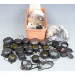 A large collection of scope mounts of various sizes together with a collection of scope covers.