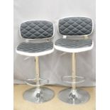A pair of contemporary bar or kitchen counter adjustable stools with quilted leather effect
