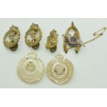 Two mother of pearl Royal Engineers brooches and three Royal Navy badges