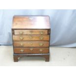 A 19thC oak bureau with leather inset tall flap, fitted interior and four graduated drawers raised