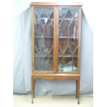 A late 19th/20thC inlaid mahogany astragal glazed display cabinet/bookcase on stand with dogtooth