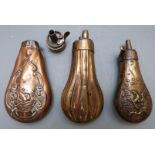 Three small copper and brass pistol or revolver powder flasks, two with embossed decoration and