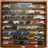 Ninety-four Lledo and similar diecast model vehicles in three wooden shelf displays together with