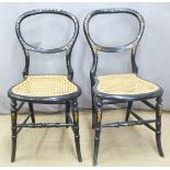 A pair of Victorian mother-of-pearl inlaid ebonised balloon back bergere chairs in the style of