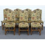 A set of seven upholstered oak dining chairs