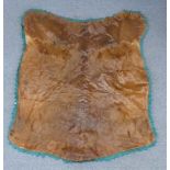 A moose skin mounted on a fabric backing with velvet surround by the National Fur and Tanning Co,