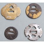 Four Japanese Samurai sword tsuba, some with pierced and gilt decoration, largest 8.5cm in diameter.