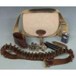 A collection of shooting and gun accessories comprising a Musto canvas and leather cartridge bag,