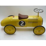 Vilac pressed steel push along 'pedal' car with yellow body, rubber tyres and racing number 2,