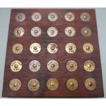 Display of twenty-five brass rifle butt stock discs for Maidstone Grammar School Junior Training