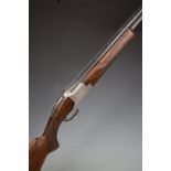 Browning B2 12 bore over and under shotgun with engraved scenes of birds to the locks and underside,