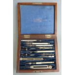 A 19thC / early 20thC Stanley mahogany cased set of drawing instruments, some with bone handles