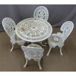 A decorative cast metal circular garden table and four chairs, diameter 80cm, height 70cm