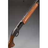 Remington model 1100 12 bore semi-automatic shotgun with ornately carved semi-pistol grip and