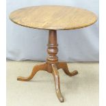 A 19thC oak tilt top table raised on a turned support and triform base, diameter 80 x H70cm