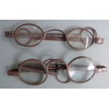 Two pairs of Georgian steel spectacles, one marked 100, width of larger when closed 11.5cm