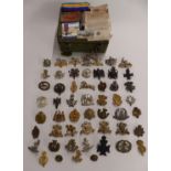 Small collection of military metal and cloth badges, rank insignia, buttons etc