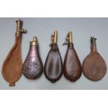 Five shot and powder flasks comprising one copper and brass with embossed decoration of dogs