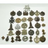 Approximately 30 WW2 plastic headdress badges including Queens, East Surrey, 4 RWF etc