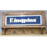 A pine mirror-backed advertising coat rack 'Kingpins', 63 x 18cm