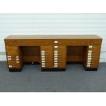 Shopfitting / haberdashery mahogany double twin pedestal desk with veneered top, the desk with an