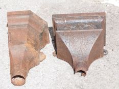 Two cast iron rainwater hoppers / planters, one with floral decoration, and a corner hopper, tallest