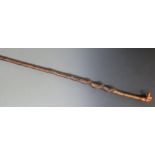 Carved wooden walking stick with pommel in the form of a dog's head and spiralling shaft, L130cm