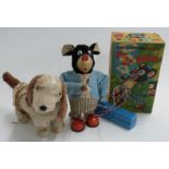 Two Japanese tinplate battery operated remote control toys Marusan (San) Smoking Pa Pa Bear in
