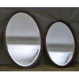 Two oval bevelled glass mirrors, one with inlaid frame, largest 65 x 95cm