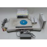 Nintendo Wii video games console together with a Wii Fit board and eight games.