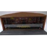 A scratch built 1:18 scale workshop or garage diorama fitted with electric lights featuring an e-
