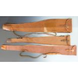 Three canvas and leather shotgun or rifle gun slips including one London Gun Company.