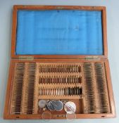 Early 20thC optician's set including one with red glass cylinders, in original case, width 44.5cm
