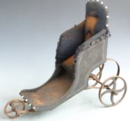Victorian upholstered dolls' bath chair with cast iron wheels, button back fabric, sprung suspension