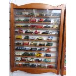 One-hundred-and-twenty Matchbox, Lledo and similar diecast model vehicles, in two glazed wooden