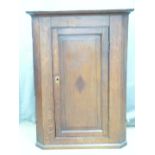 A 19thC inlaid oak hanging corner cupboard, W66 x H98cm