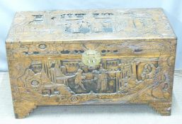 A mid-20thC Eastern carved camphorwood chest with lift out tray, Hong Kong label within, W89 x D42 x
