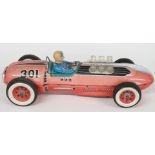 Masudaya Japan tinplate battery operated model racing car with red body, blue driver, red and