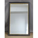 A mirror with gilt border and reeded ebonised frame, 93 x 58cm