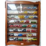 One-hundred-and-one Matchbox, Lledo and similar diecast model vehicles, in three wooden display