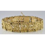 A 14k gold bracelet with retro bark effect and pierced design, 30.8g