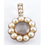 Victorian rose gold locket set with split pearls with a central glass compartment, diameter 2cm