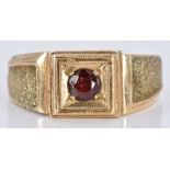 A 9ct gold signet ring set with a garnet, 6.8g, size T