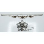 A silver necklace set with garnets and a silver brooch set with heart cut paste (55.3 diam). 38.3g