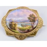 Victorian brooch set with a miniature enamelled landscape with script verso 'Vue de Geneve over Le