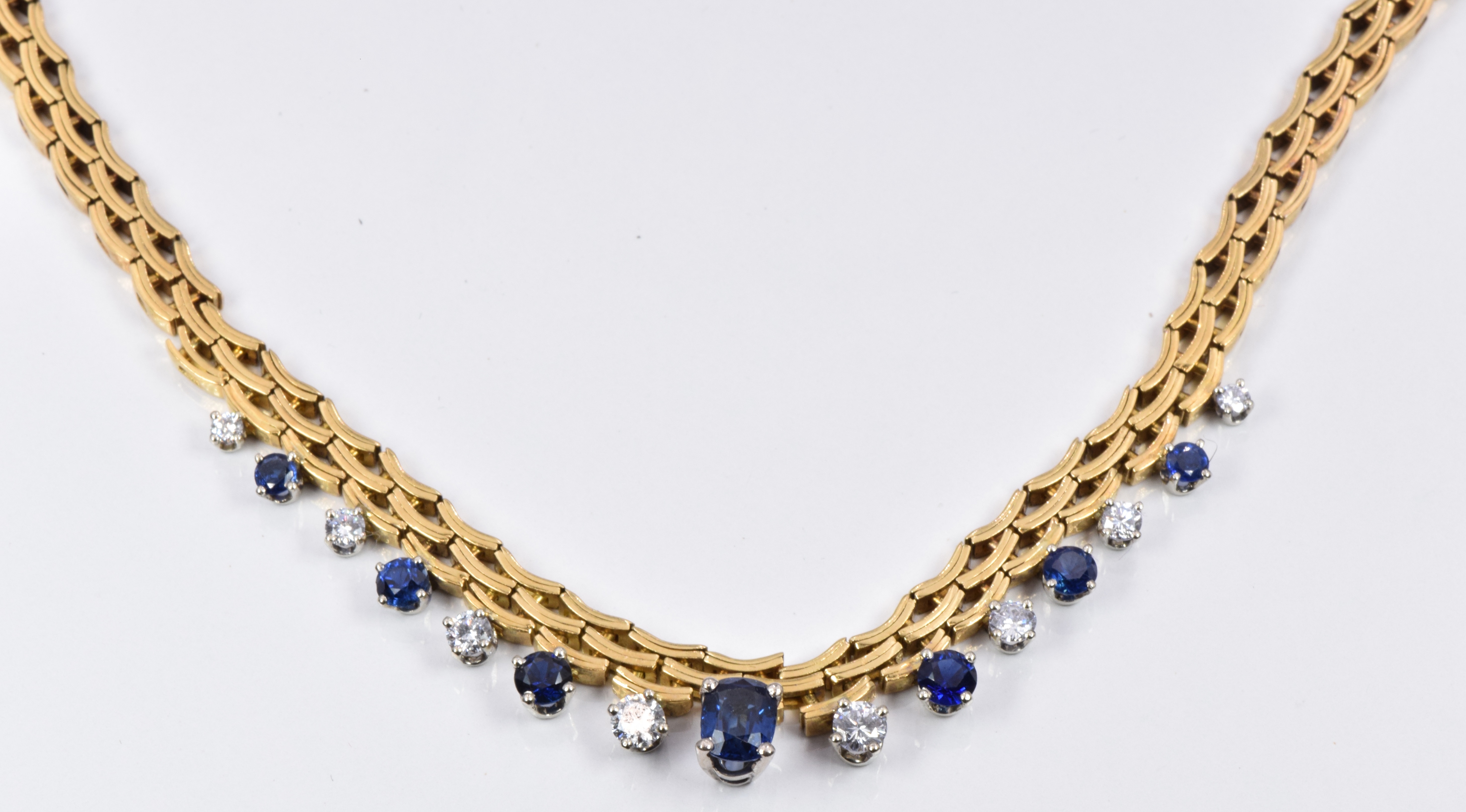 Gubelin 18ct gold necklace set with an oval cut sapphire of approximately 0.68ct, six round cut - Image 3 of 4
