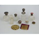 Two hallmarked silver topped dressing table bottles including an inlaid tortoiseshell example,